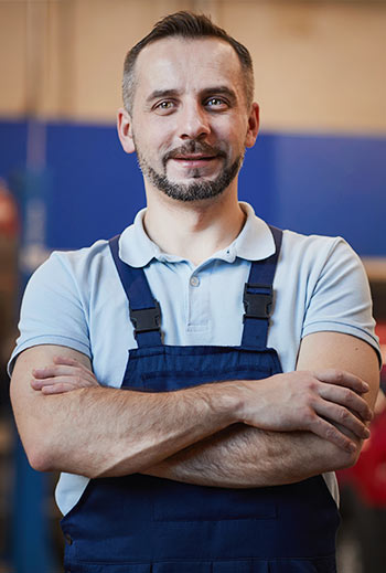 car mechanic posing in shop