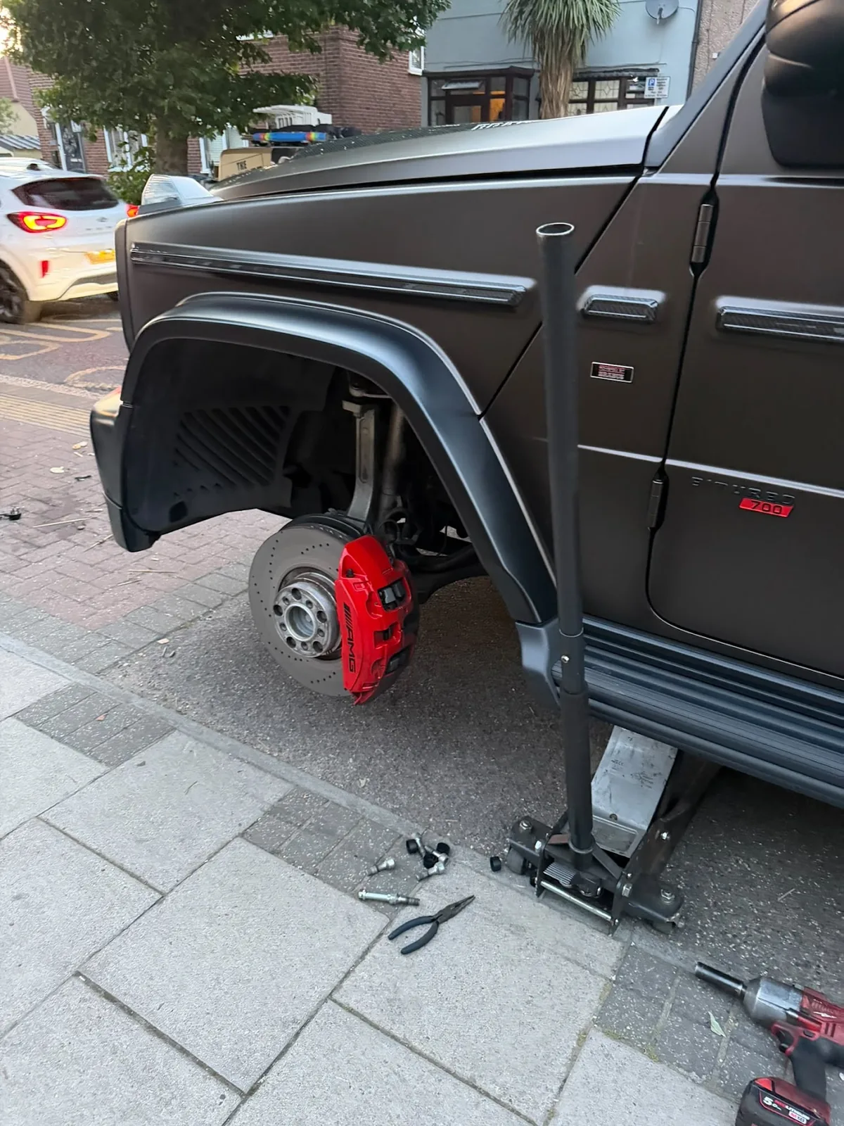 Mobile tyre technician working on a vehicle tyre